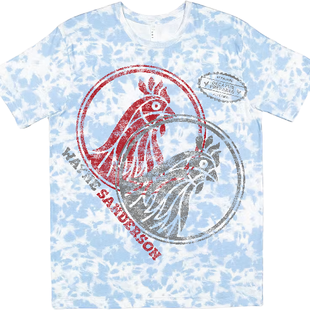 A light blue and white tie-dye t-shirt featuring a graphic print of two roosters inside a circular frame, with the text 'Waffle Sanderson' and a 'Vintage Tobacco Company' label on the chest.