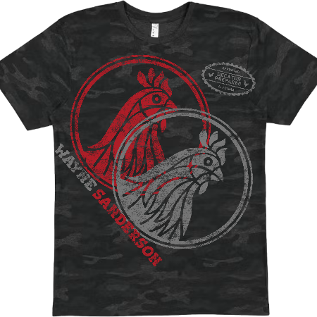 A dark gray and black camouflage t-shirt featuring a graphic of two roosters inside circular frames, with red and gray distressed text reading 'HAYSE SANDERSON' and a circular badge that says 'READY FOR BATTLE'.